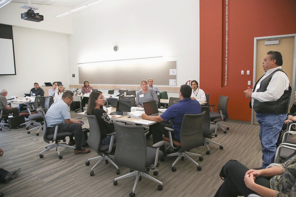 A training room where participants work on laptops